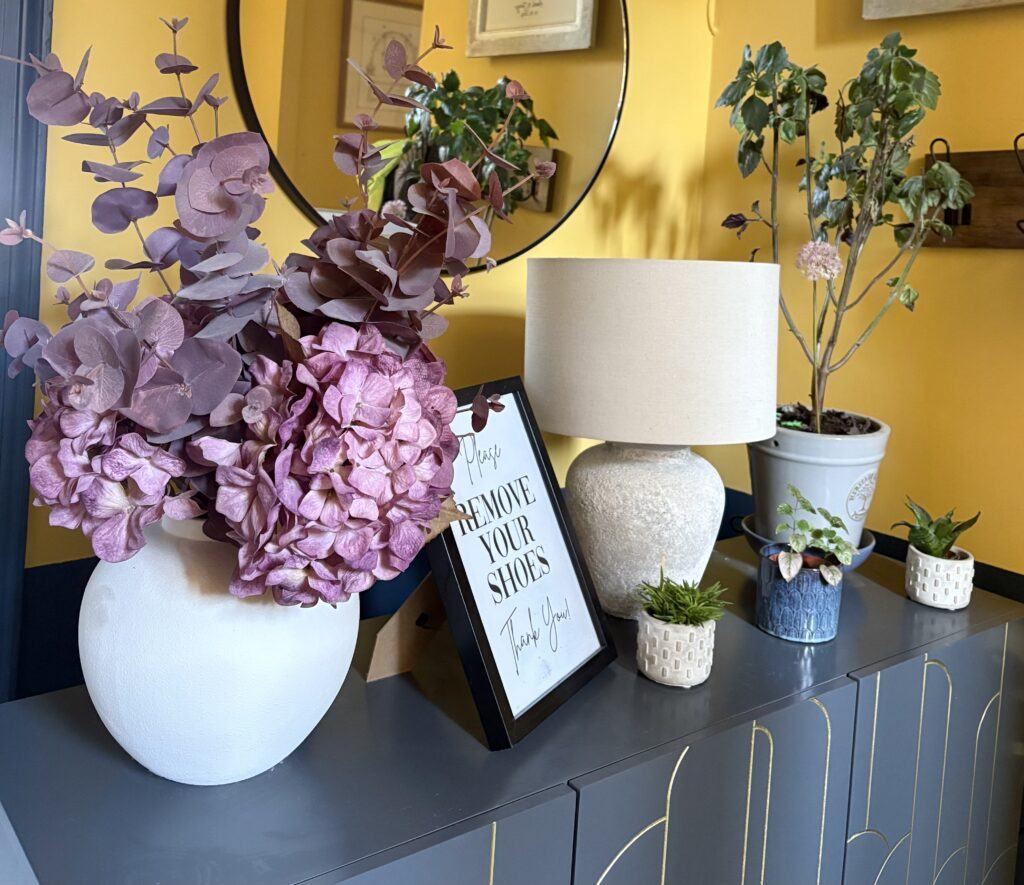 sideboard with indoor and artificial plants