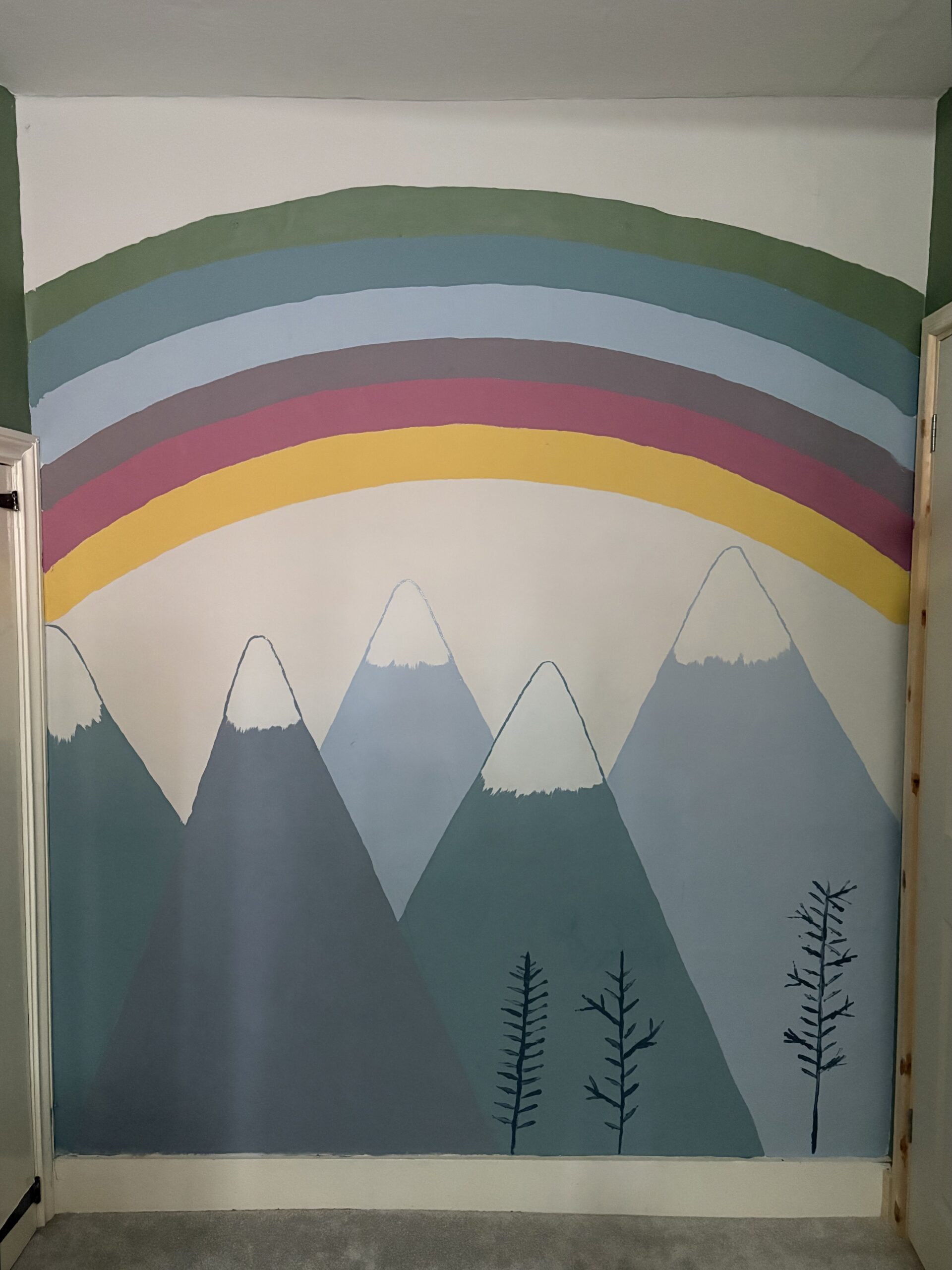 rainbow and mountains painted in a playroom